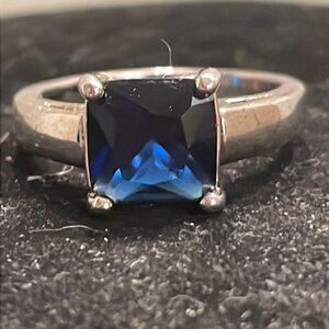 Size 8.75 polished silver tone emerald cut prong set blue sapphire like ring